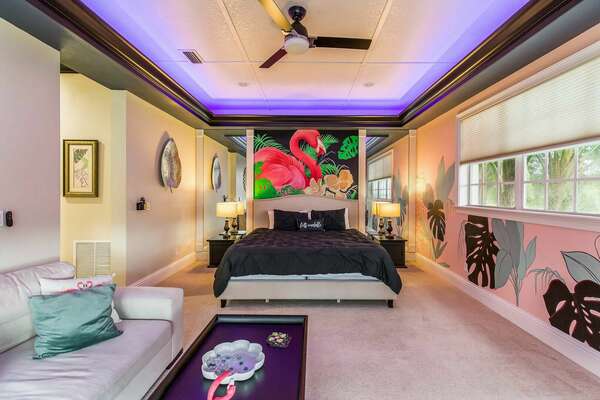 Enjoy this tropical and colorful second bedroom with a King size bed