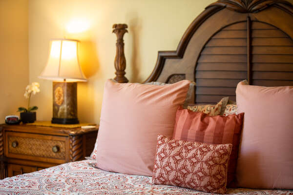 Bed with Coral Colored Pillows and Bedspread