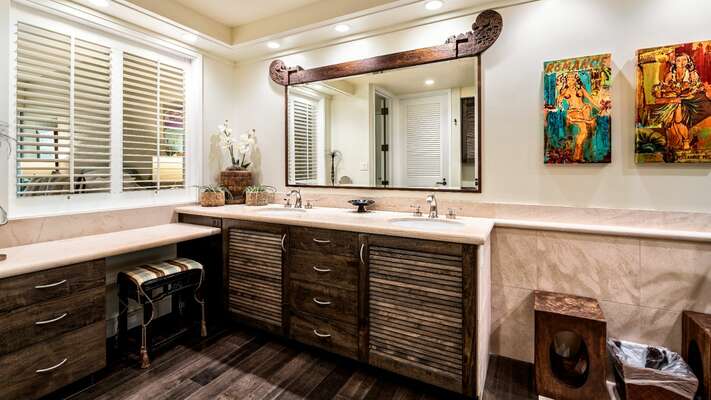 Primary en-suite bathroom with dual sinks and rich hardwood floors