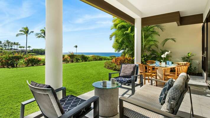 Large lanai has a circular glass table, 4 dining chairs plus 2 cushioned deck chairs & a sofa.