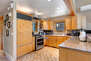 Fully Equipped Kitchen with stainless steel LG appliances, and bar seating for four