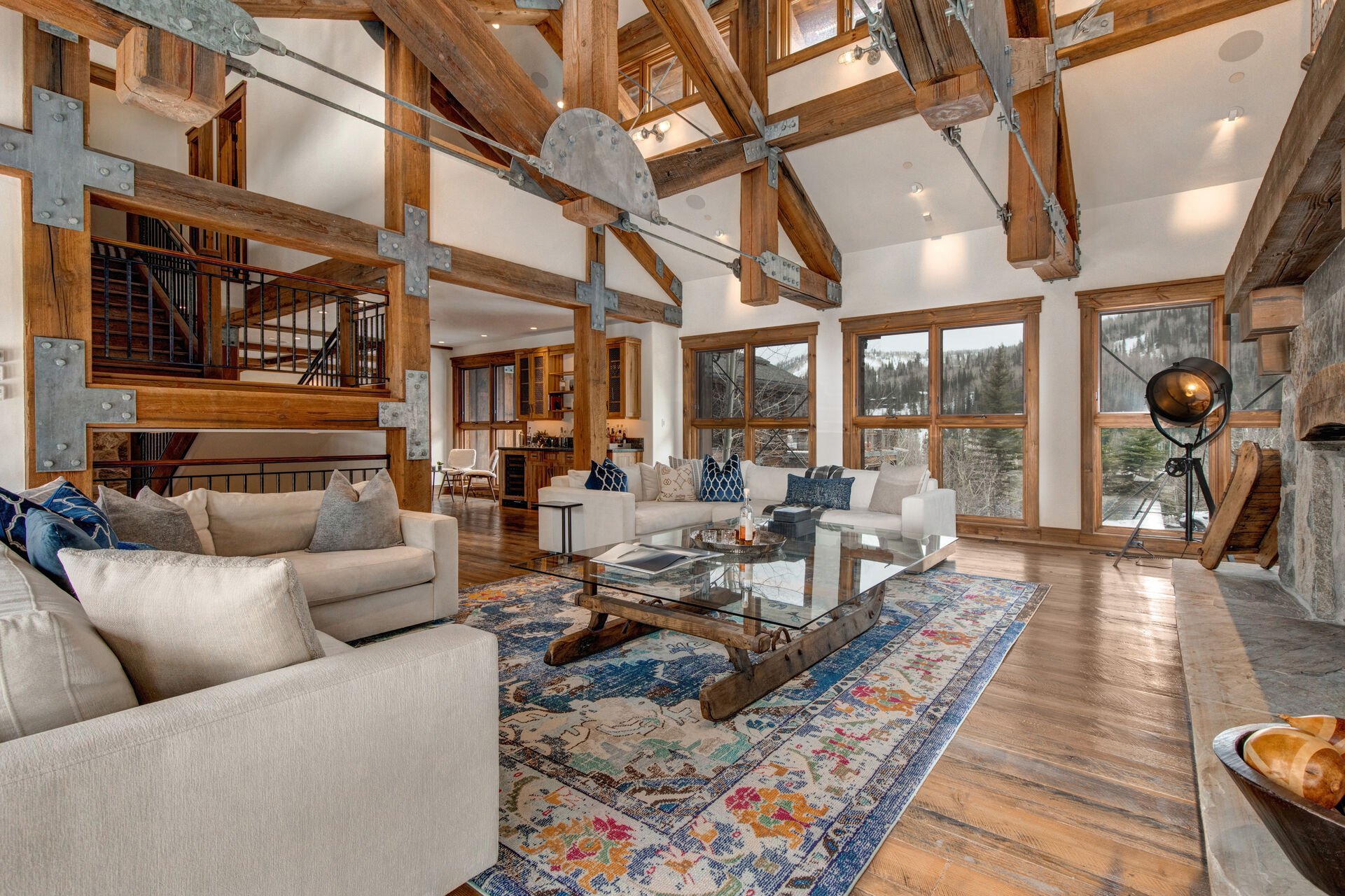Main Level Living Room with wood-burning fireplace, plush sectional sofas, and private deck access