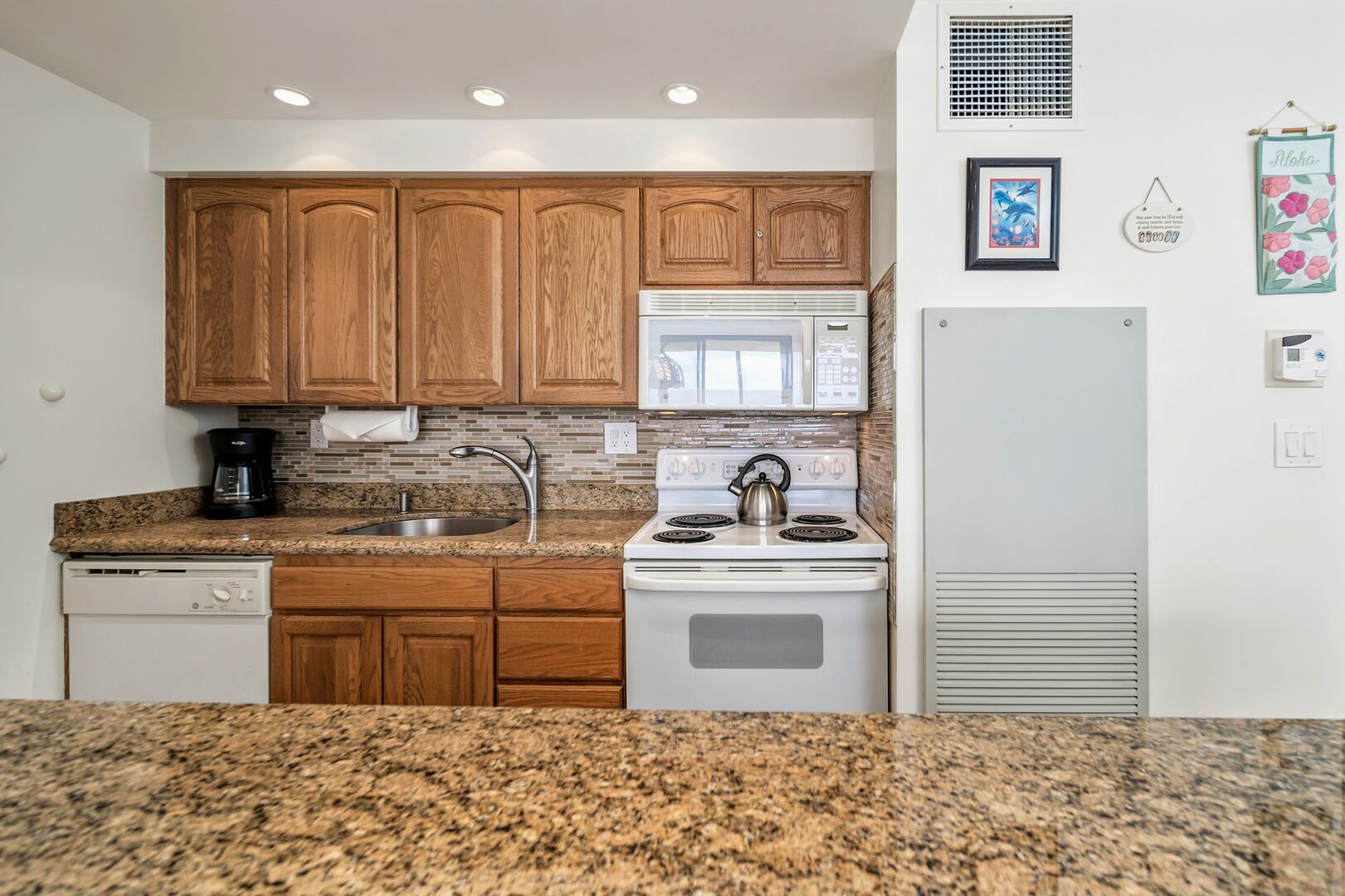 Upgraded unit with granite counter tops and glass back splash.
