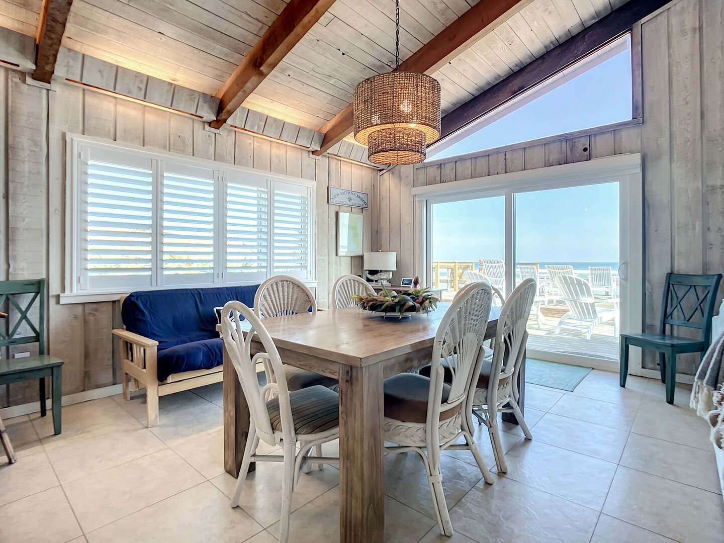 Ocean front dining area with table and seating for six.