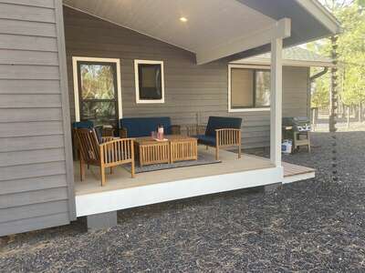 The back porch can provide a private retreat for meditation or a social space to enjoy conversation. The propane grill and picnic table offer the perfect place to make and enjoy a twilight dinner.