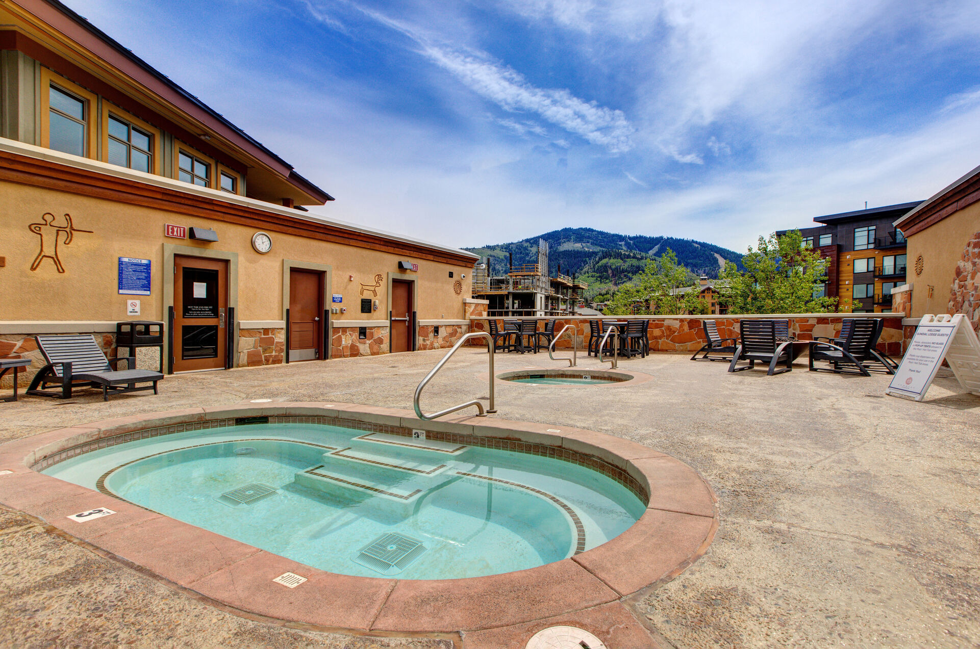 Community Amenities with outdoor firepit, hot tub, pool, fitness center, and grill area