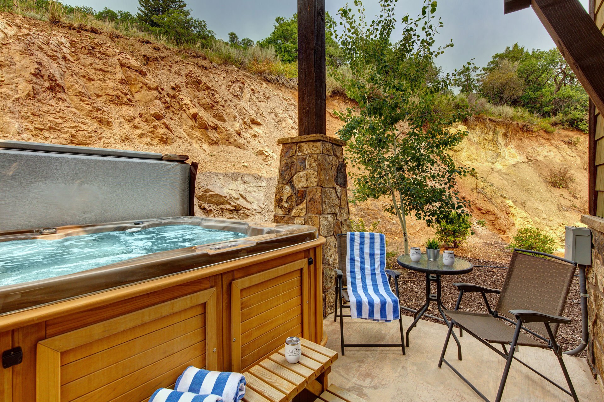 Private Hot Tub patio with seating and table for two, propane bbq, and 8-person spa