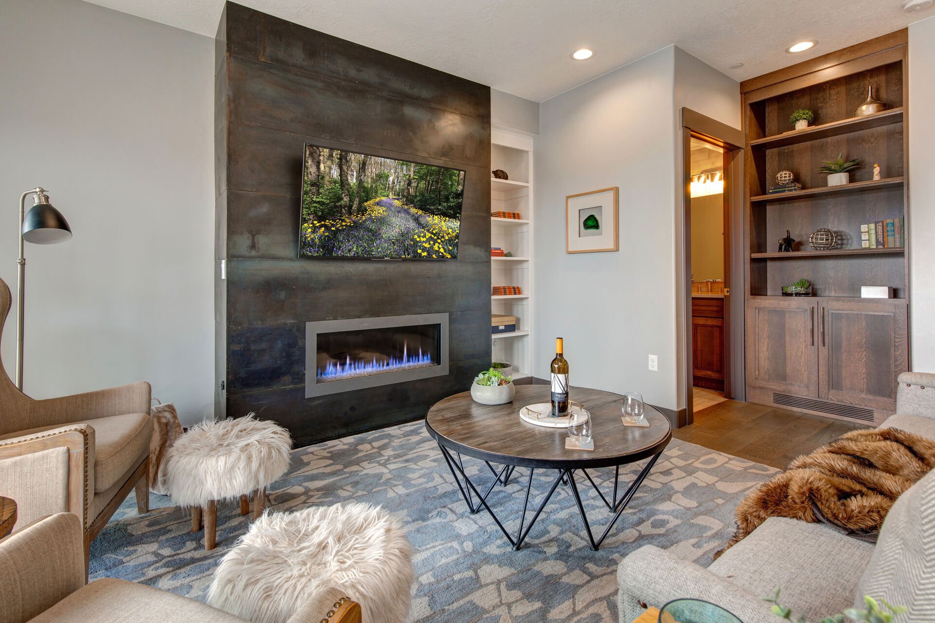 Living Room with plush contemporary furnishings, modern gas fireplace, Sony smart tv, and private balcony access

Note: New photos of living room chairs coming soon