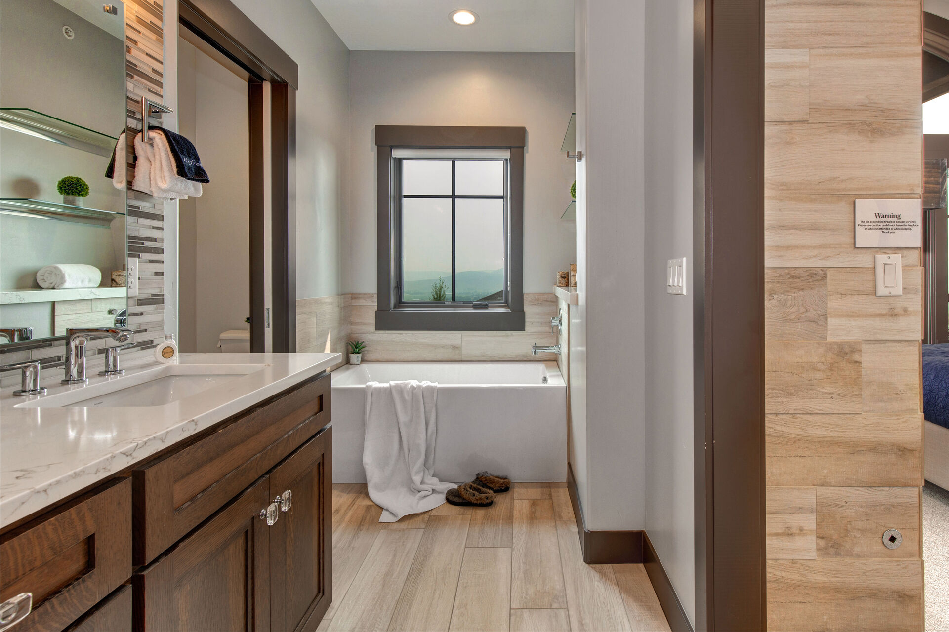 Master Bathroom with dual vanities, oversized tiled shower, private washroom, and jetted tub