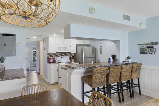 Fully equipped kitchen with bar stools