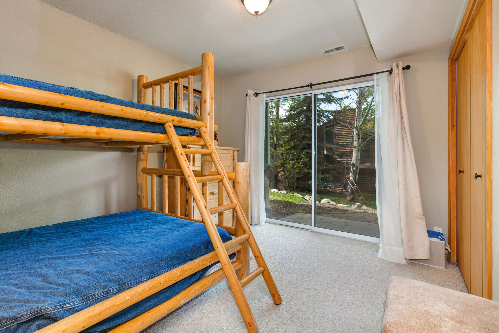 Lower Level Bedroom 2 Bunk Room with twin over full bunkbed, hot tub patio access, and en suite bathroom