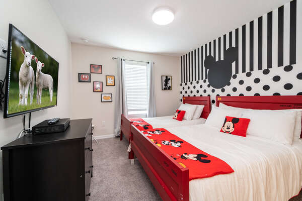 Bedroom 4 has famous mouse themed decor with single and double beds and a flatscreen TV.  Also has en-suite bathroom.