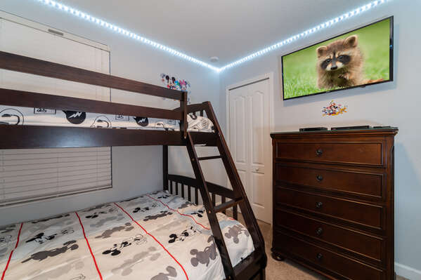 Bedroom 4 has single over full bunk beds showing LED  Smart TV