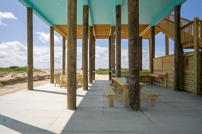 Underneath entertaining area with picnic tables and parking