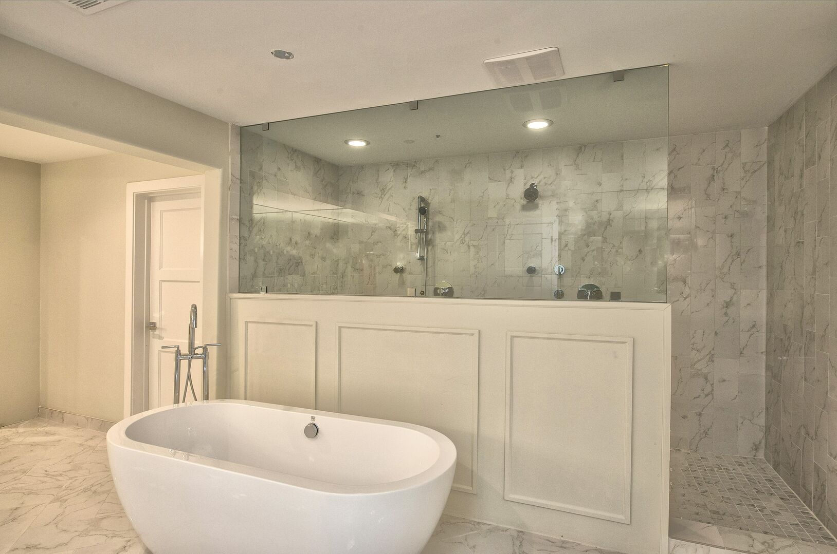 Huge master bath with 15 ft long shower, raised vessel tub, his / her vanities and large closet