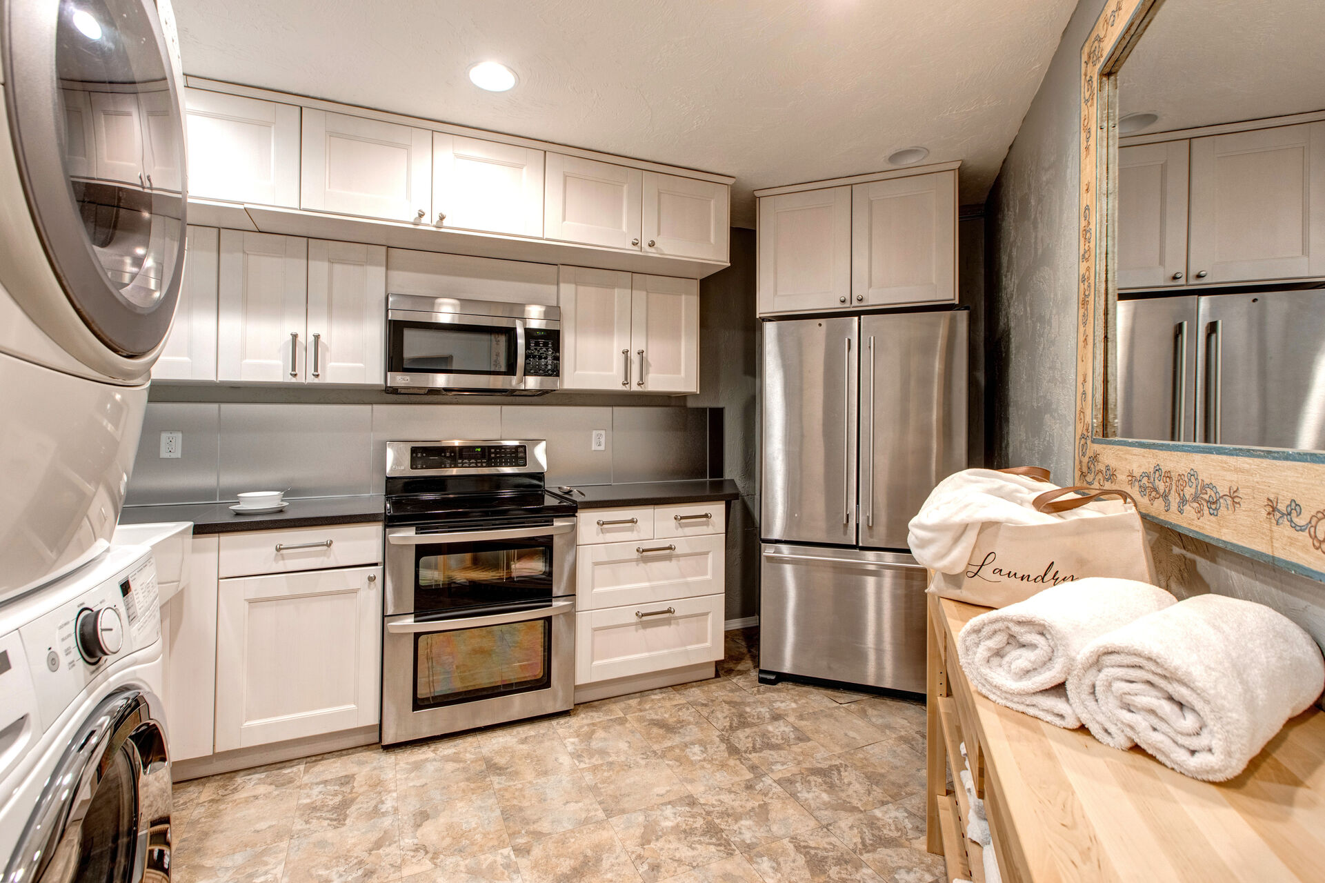 Lower Level Kitchen 2 with ample storage, stainless steel appliances, and full-sized washer and dryer units