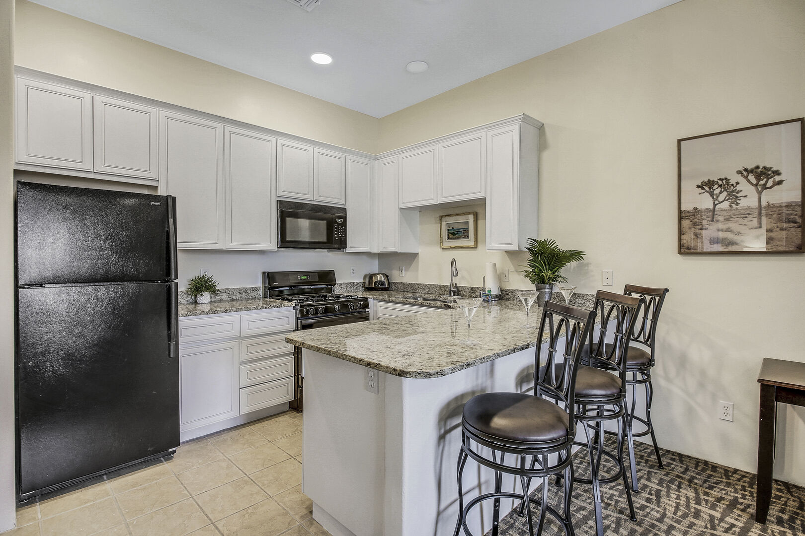 The fully-equipped kitchen features stunning appliances such as a Maytag top freezer refrigerator.