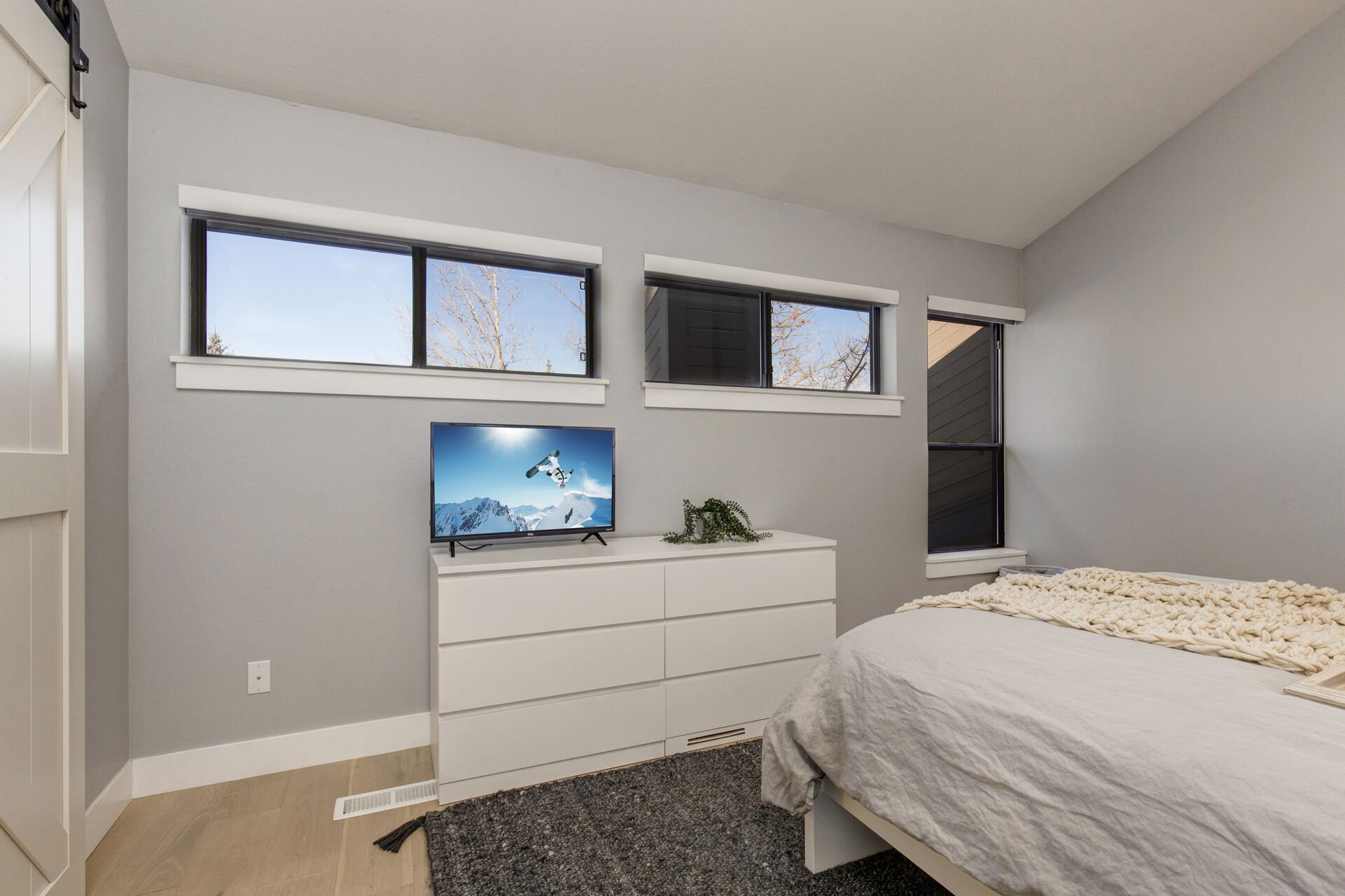 Master Bedroom with queen bed, smart tv, and en suite bathroom