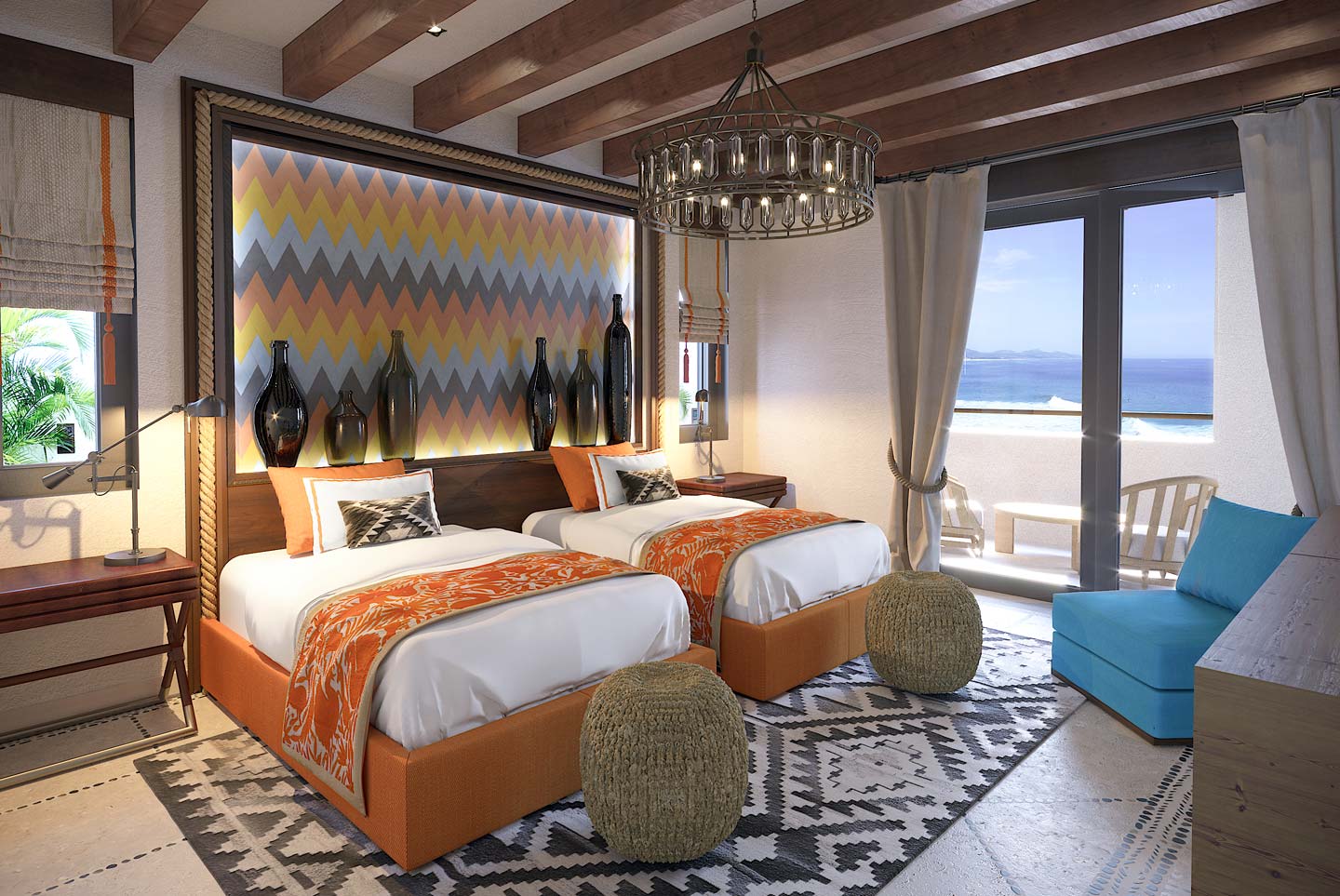 Two side-by-side beds in a bedroom of this Los Cabos beachfront villa, with colorful sheets and beach views.
