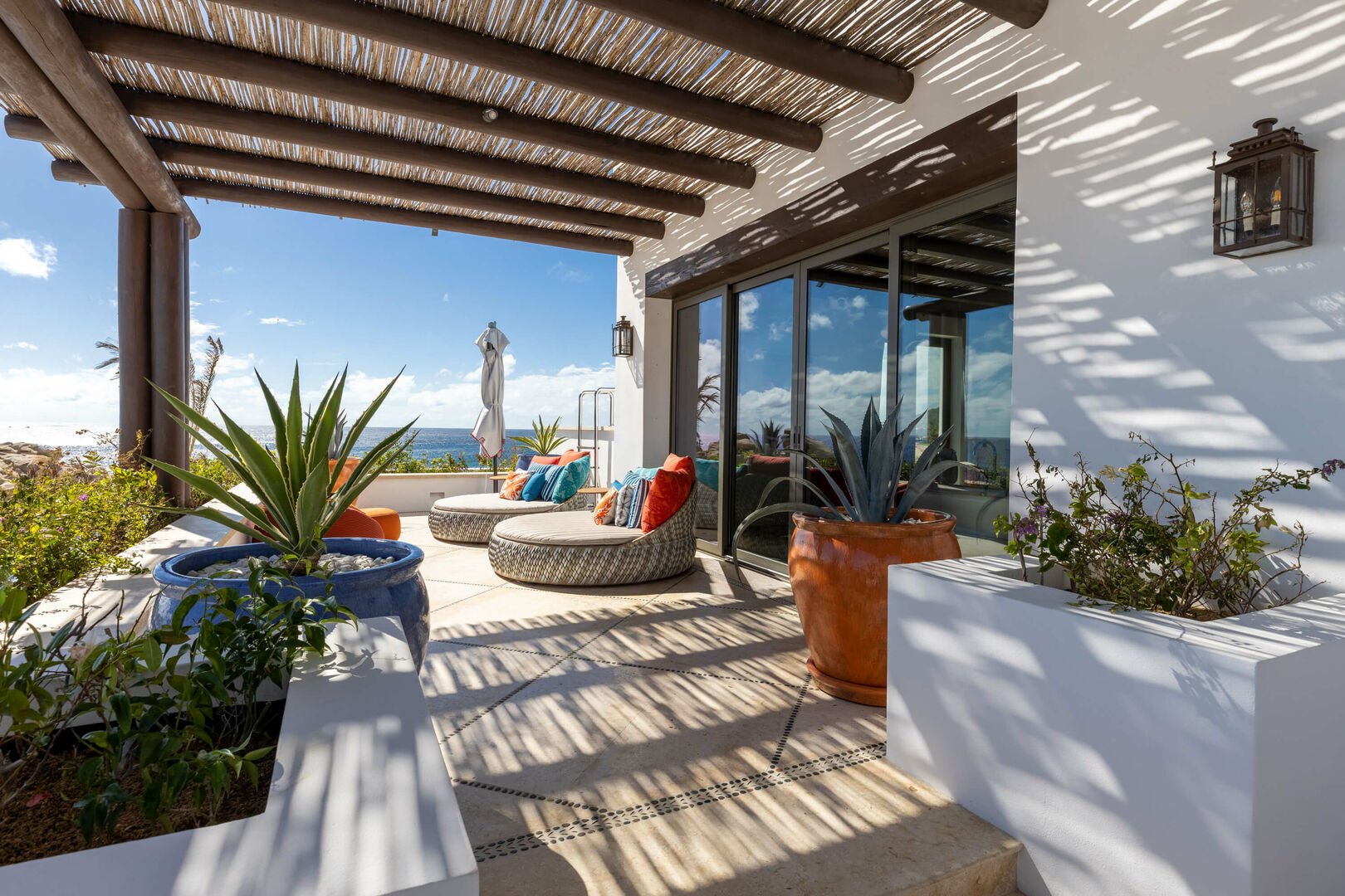 Comfortable chairs on one of the patios of this Los Cabos beachfront villa.