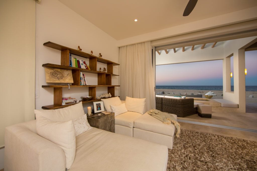 The seating of the master bedroom, with a large sliding glass door opening to the ocean.