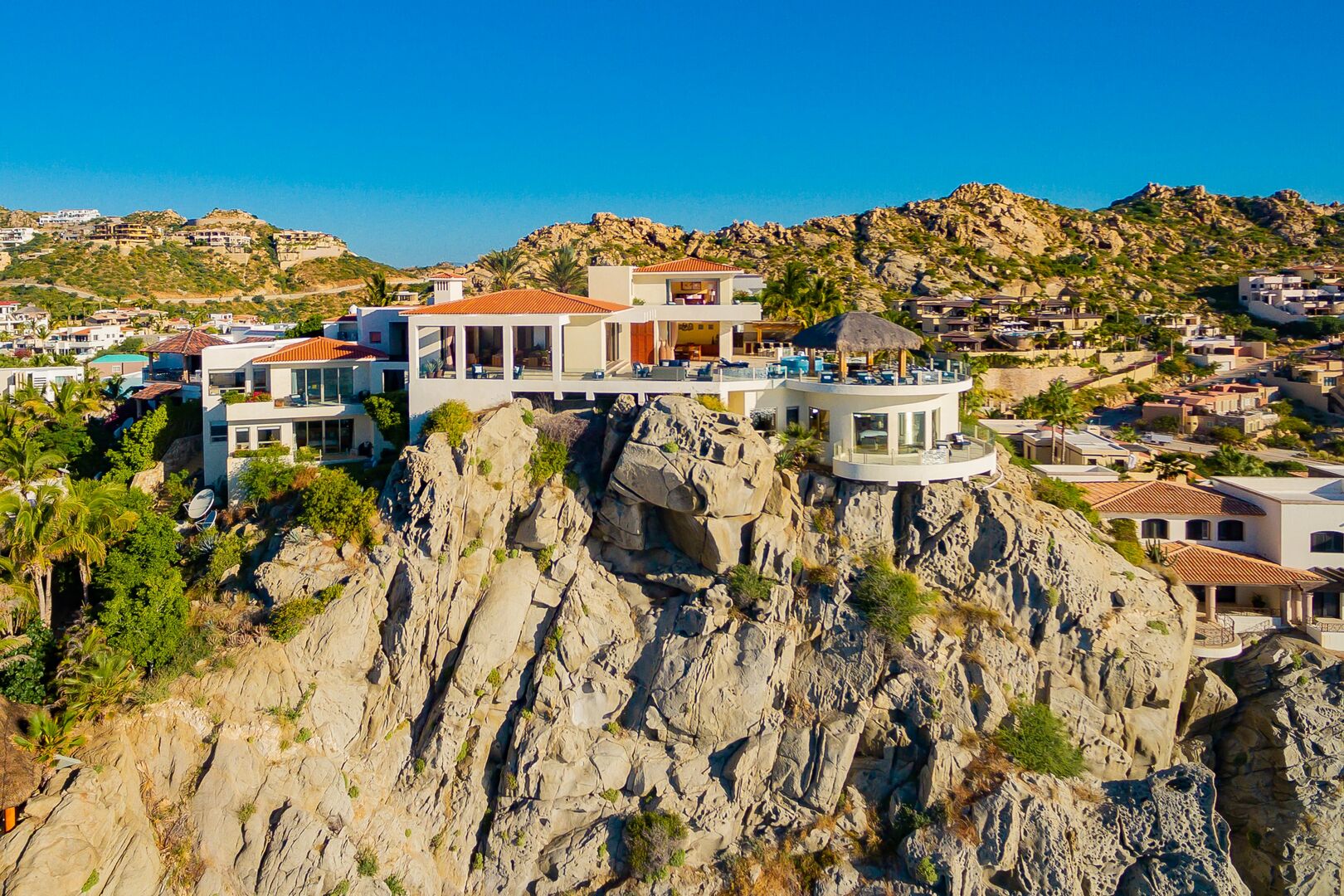 A zoomed out front view of this oceanfront home in Los Cabos.