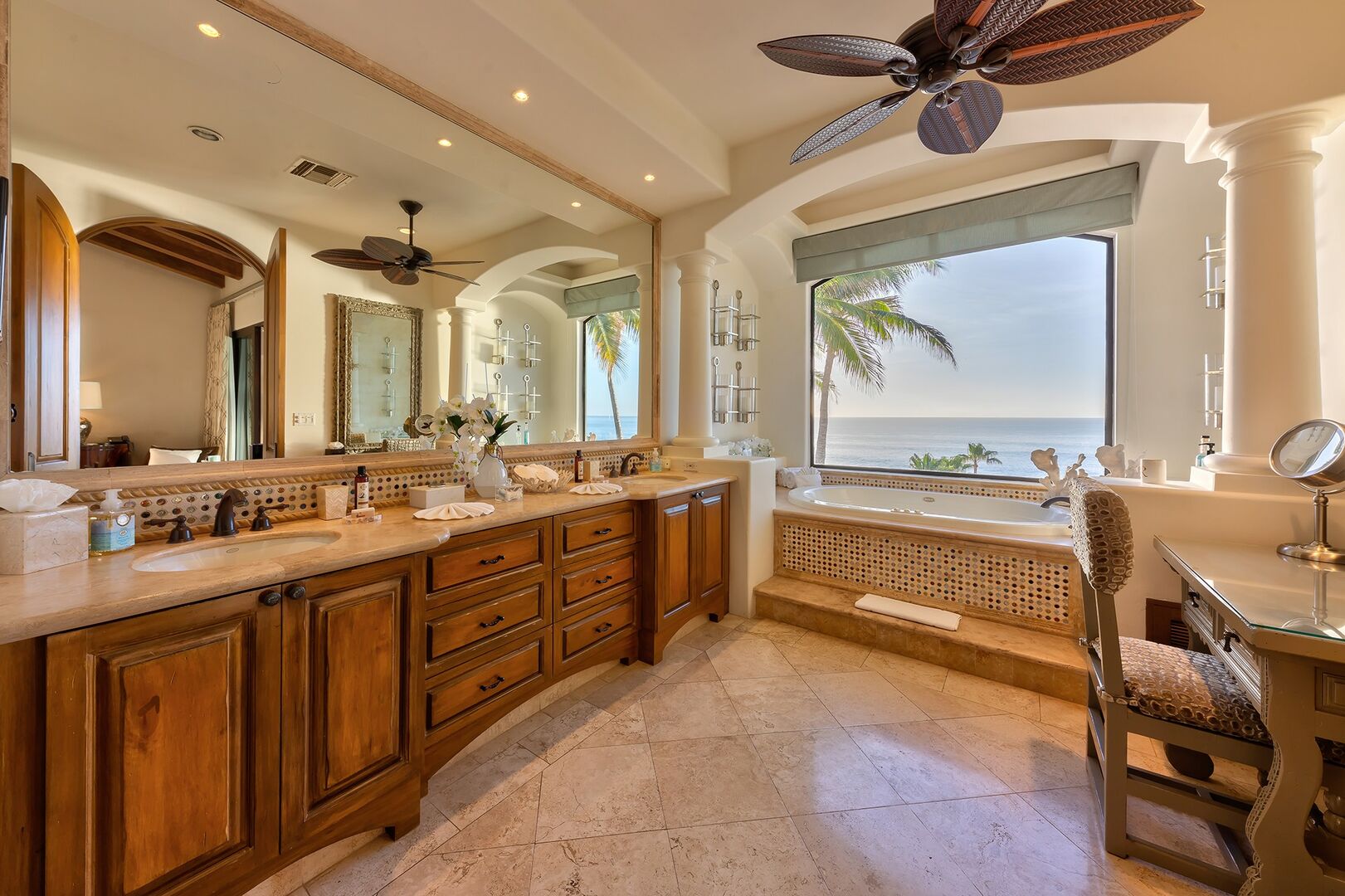 The large double vanity of the master bedroom with a view of the ocean from the window.