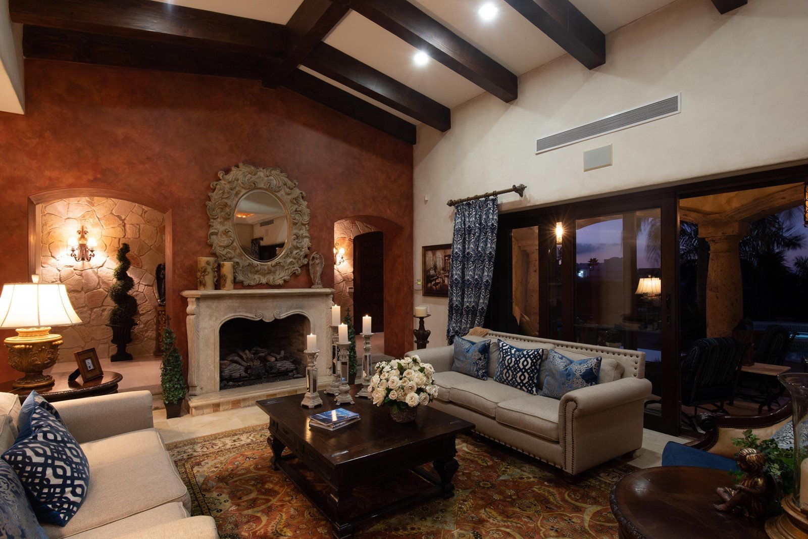 A cozy seating area with two couches next to a fireplace in the villa.