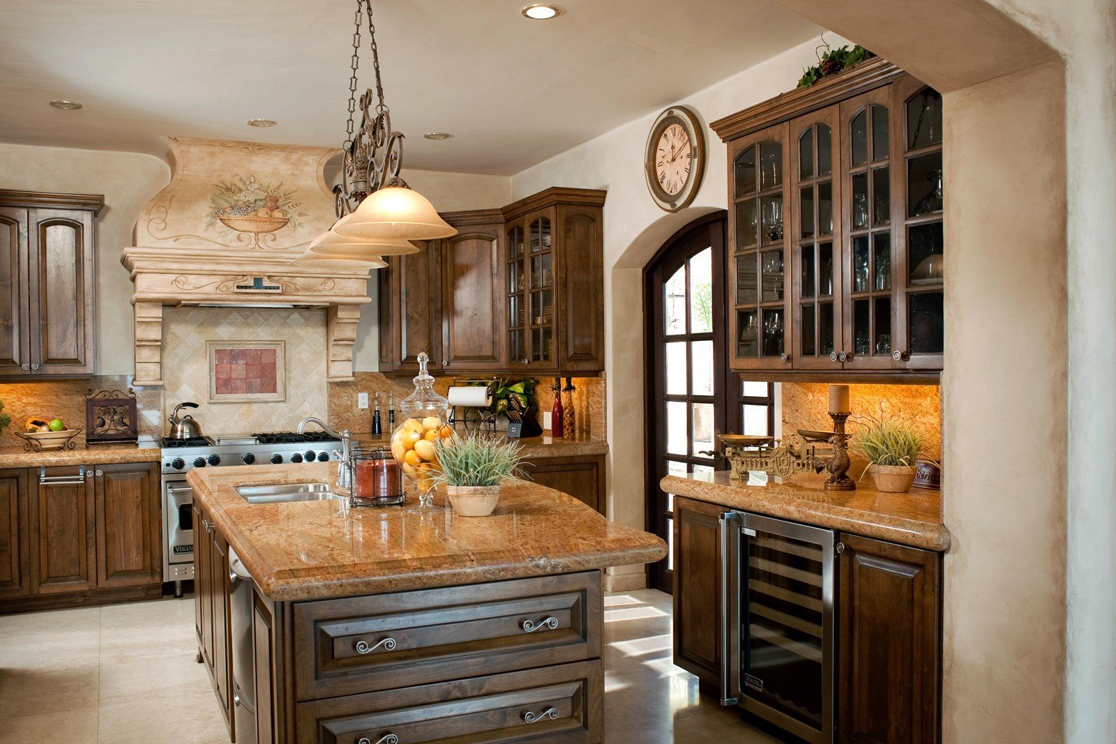 The main kitchen of the villa with a large center island and granite countertops.