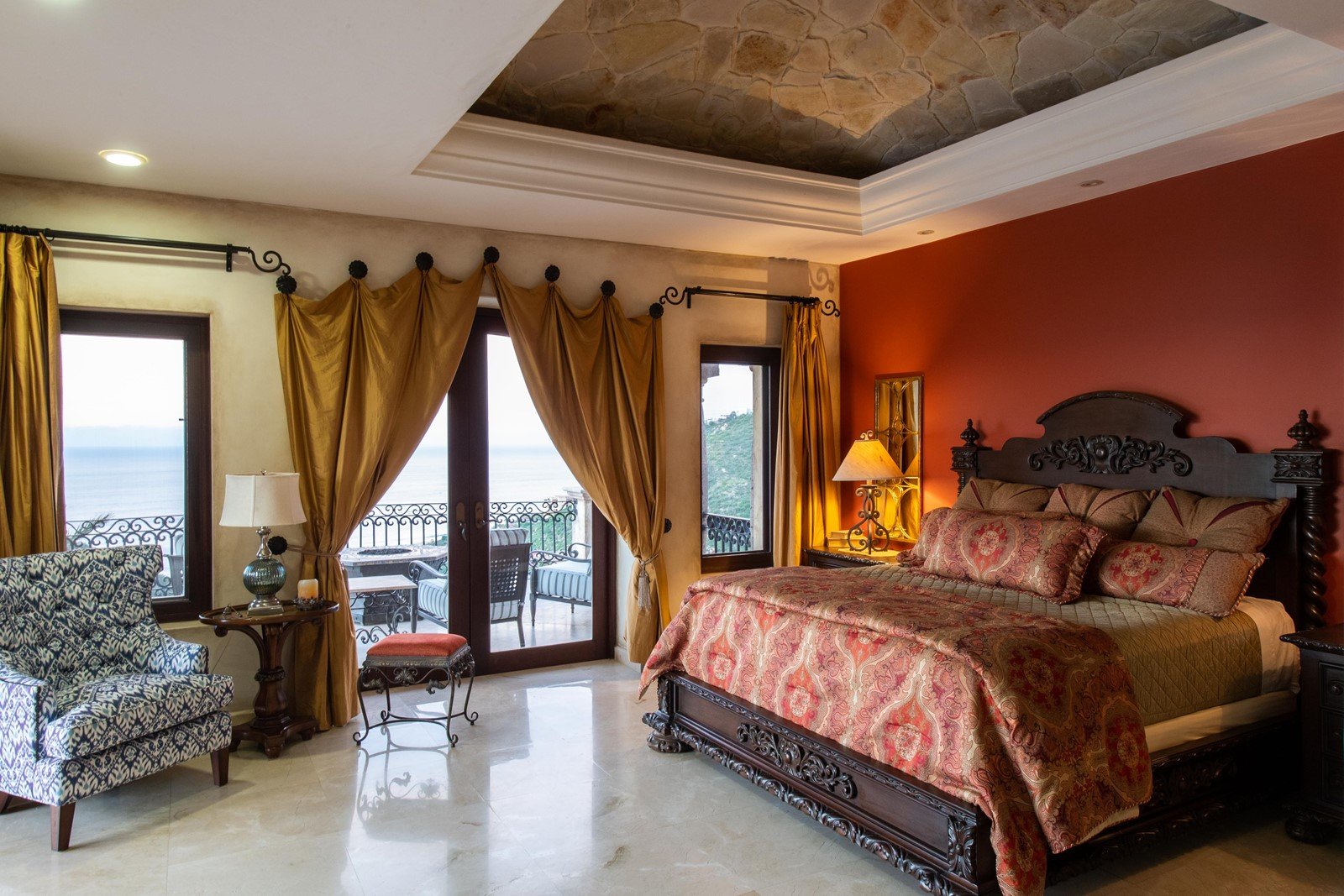 One of the bedrooms in Villa Maria with a view of the ocean from the balcony.