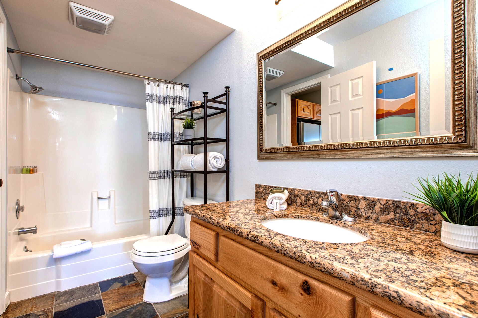 Master Bathroom with tub/shower combo, laundry closet, and jack-n-jill access to main living area