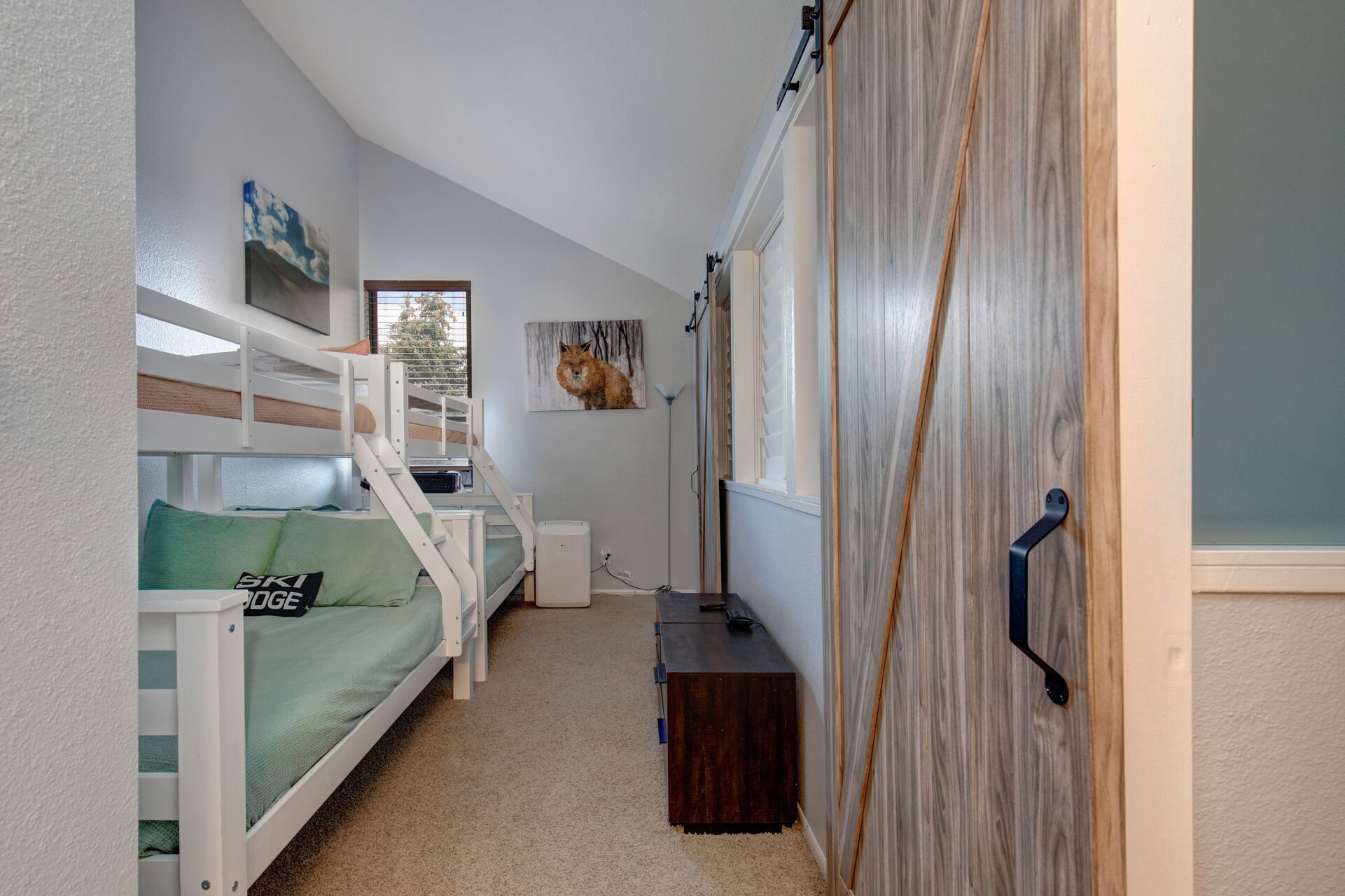 Upper Level Loft bunk area with two twin over full bunk beds and access to full bath. Sliding barn doors lead into the bunk room and separate the bunk room from the Queen bed in the loft