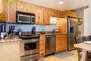 Fully Equipped Kitchen with stainless steel appliances, ice maker, stone countertops, and full bath & laundry access