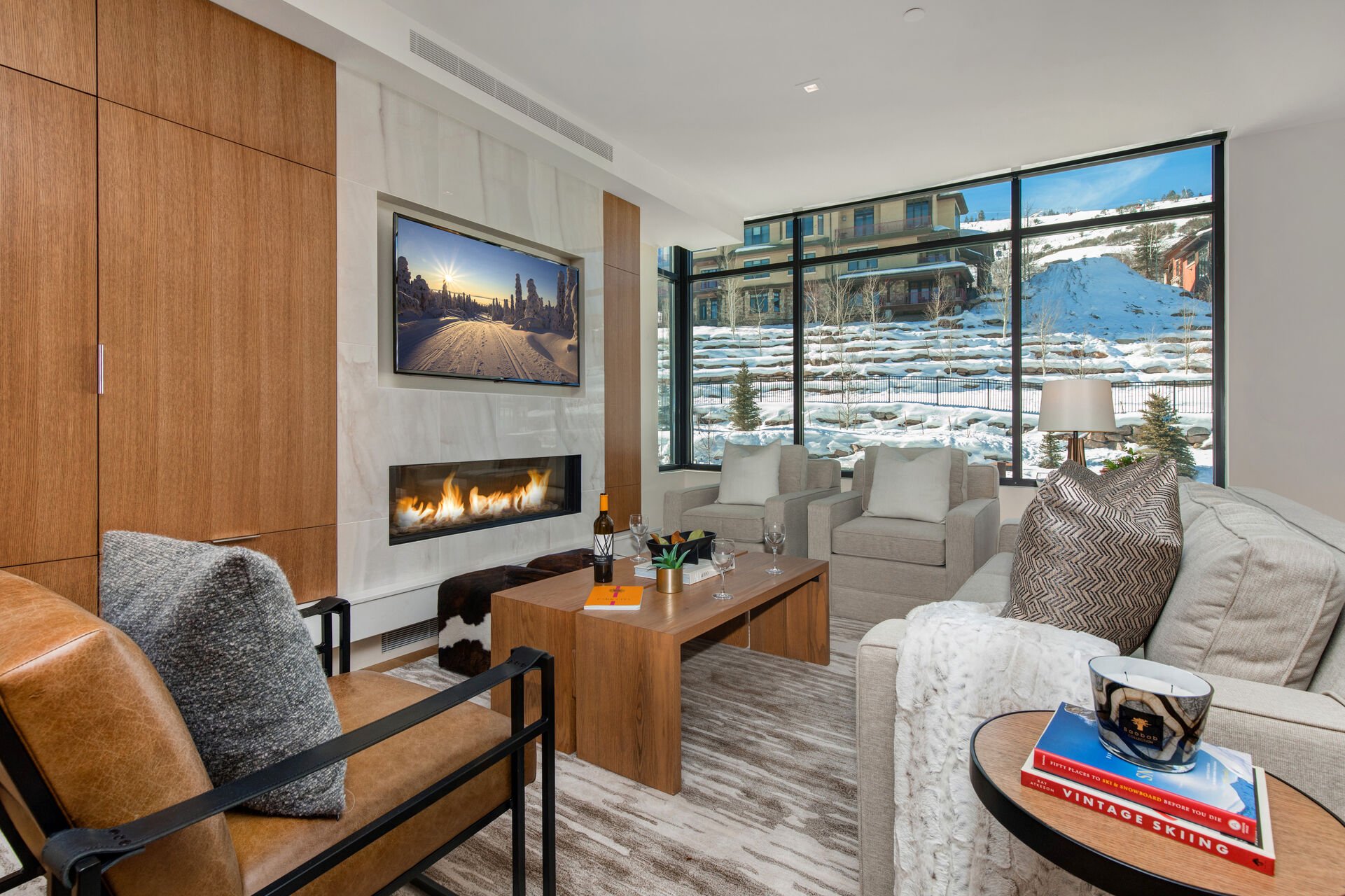 Living Room with mountain contemporary furnishings, sleeper sofa, gas fireplace, LG smart tv, and beautiful pool and resort views from the private balcony