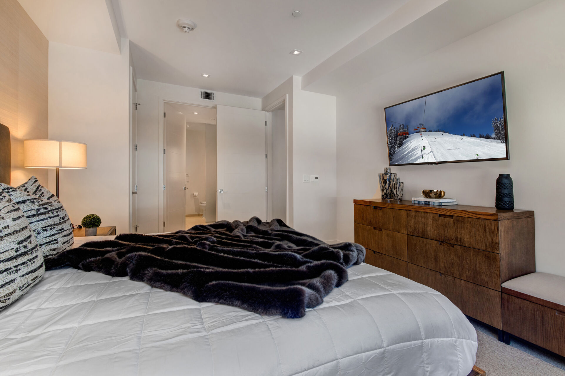 Master Bedroom with king bed, LG smart tv, reading bench, and en suite bathroom