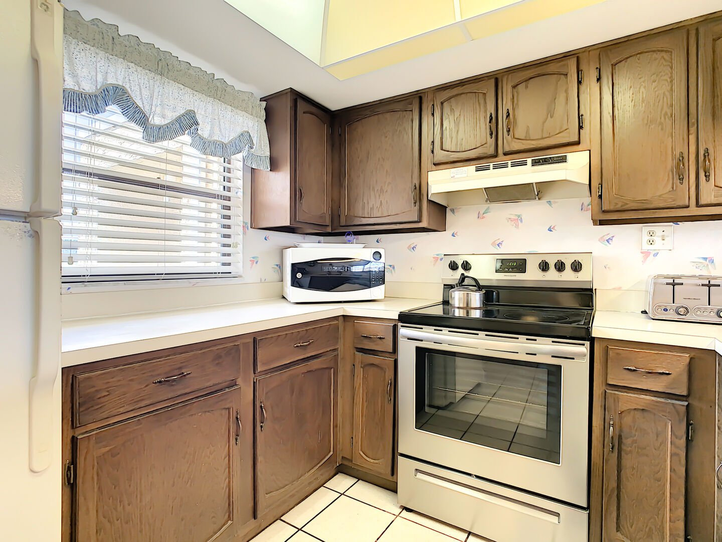 Kitchen with small appliances and large stainless steel oven