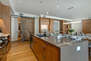 Fully Equipped Kitchen with gorgeous stone island, stainless steel appliances, and seating for 4