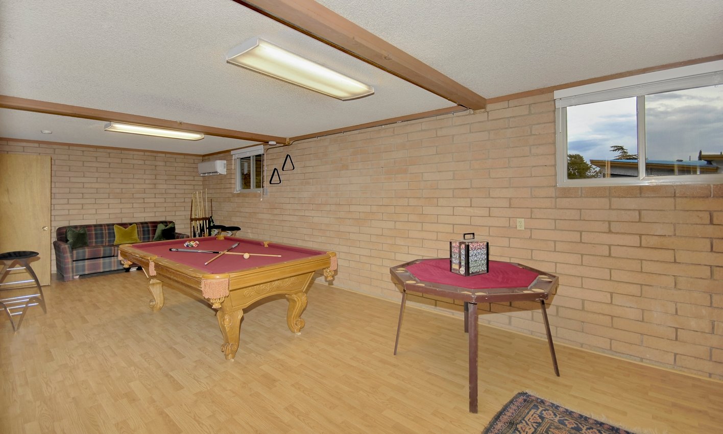 Downstairs game room with billiards and poker tables