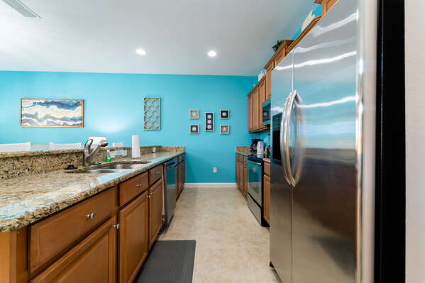 Galley style kitchen has brushed stainless appliances