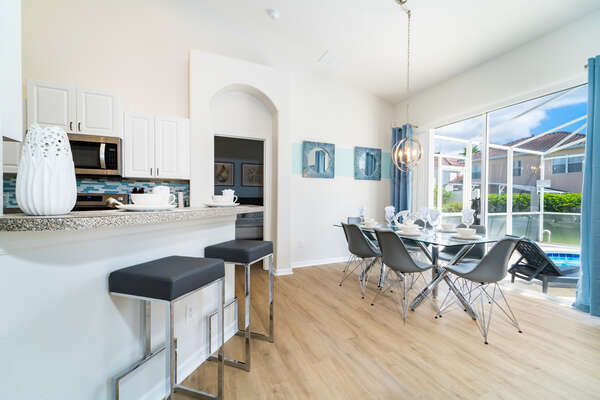 breakfast bar and dining area in an open concept setting