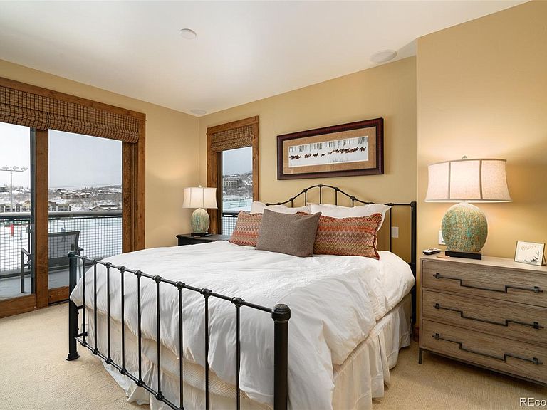 The luxurious master bedroom with en suite bathroom, gas fireplace and private deck overlooking the Stampede ski run.