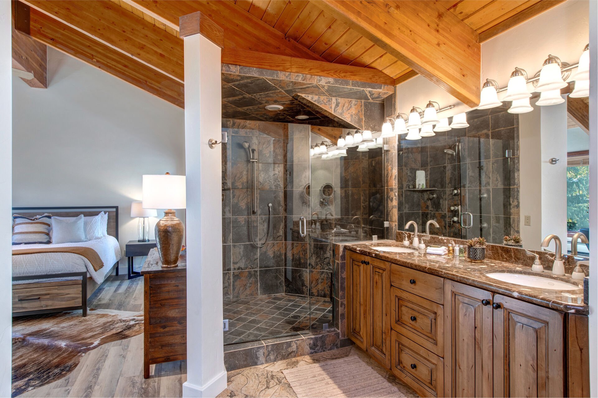 Grand Master Bathroom with dual vanities, beautiful stonework, tile & glass shower, and large jetted soaking tub