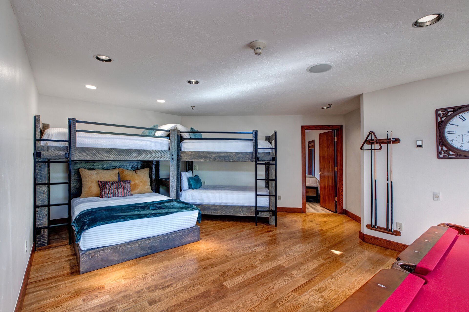 Lower Level Game/Sleeping Room with twin over twin and twin over queen bunks, high-top table for two, pool table, full bathroom, mudroom and private hot tub patio access
