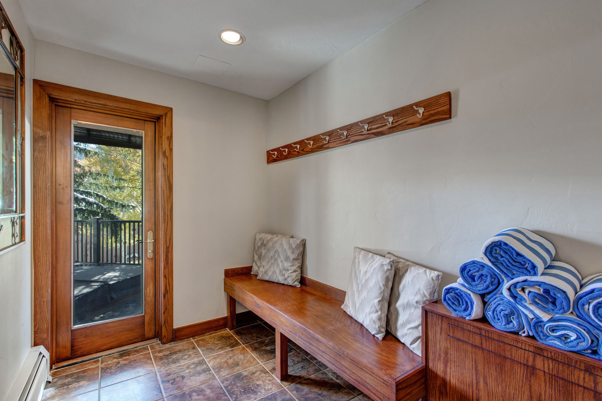 Lower Level mudroom with convenient bench and hooks as well as private hot tub patio access