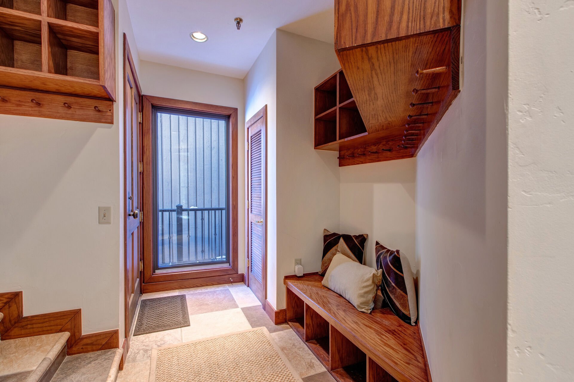 Entryway with convenient bench, coat & equipment hooks, and storage cubbies