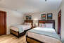 Lower Level Bedroom 4 has two full beds with storage, Samsung smart tv, and game room & full bath access