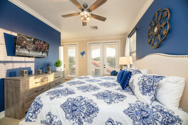 This master suite on the third floor features a king-sized bed and private balcony with neighborhood views