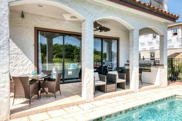 Cook outside in the summer kitchen with BBQ grill and dine al fresco at one of the 2 patio tables, each seating 4