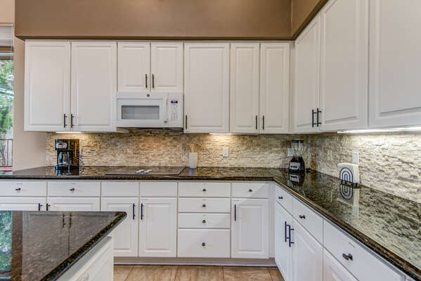 Plenty of Stone Counter Space and Cabinets