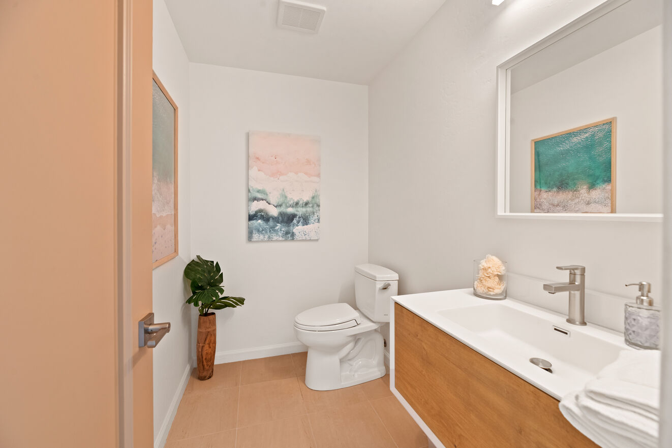 Modern remodeled half bath convenient to entry, dining room and kitchen